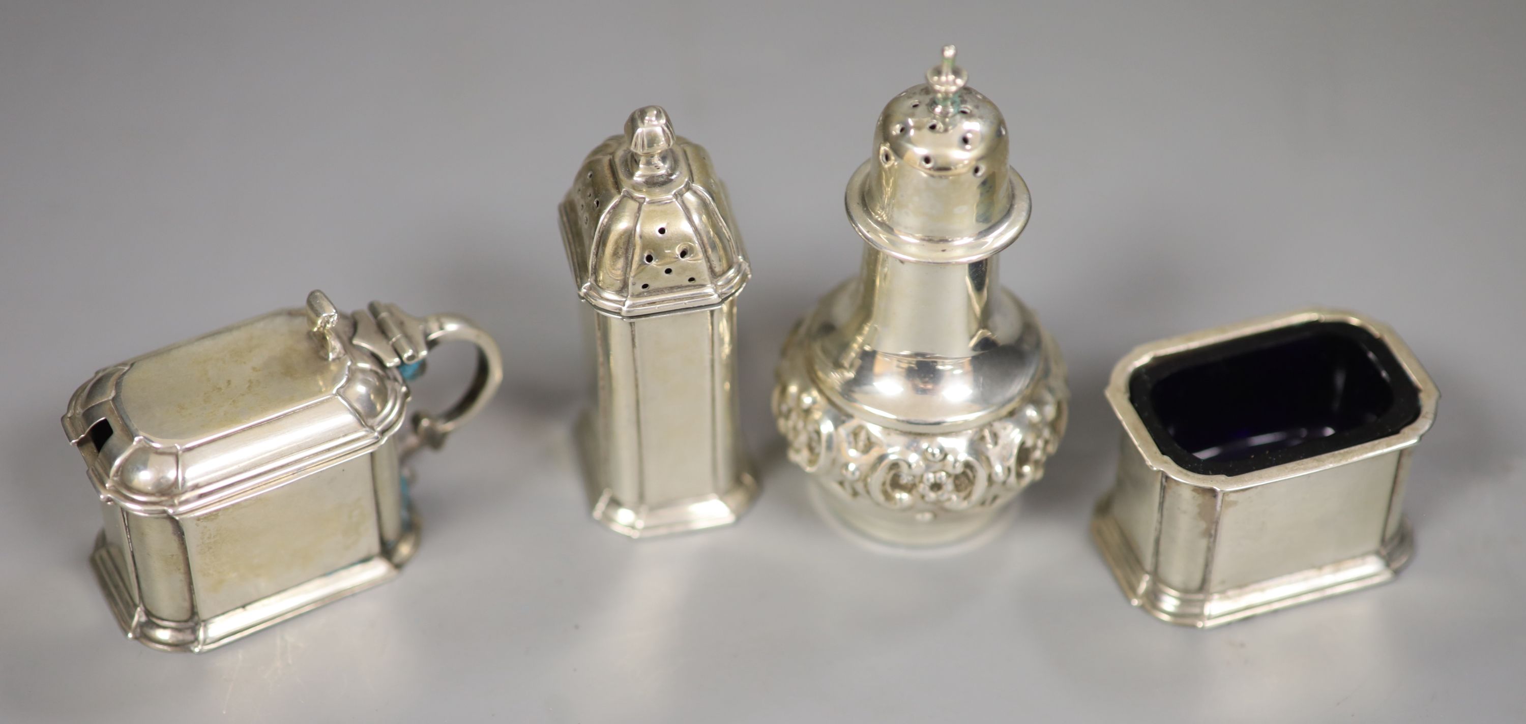 A George V three piece silver cruet set, Harrods Ltd, Birmingham, 1934 and a silver pepperette.